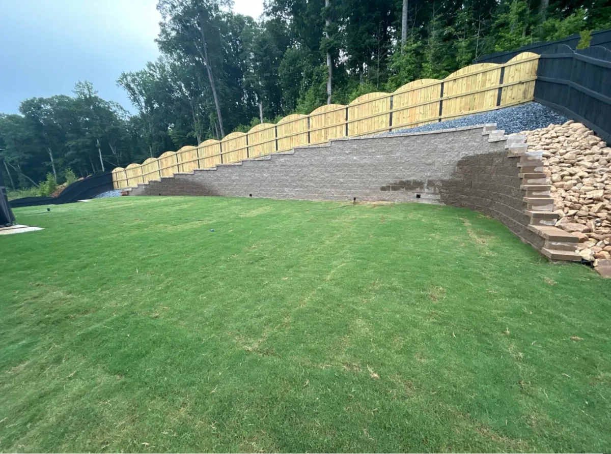Retaining wall with sod and rock restoration in Alpharetta, Georgia